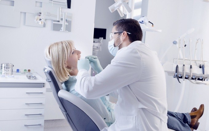 Dentist performing a dental exam on a female patient