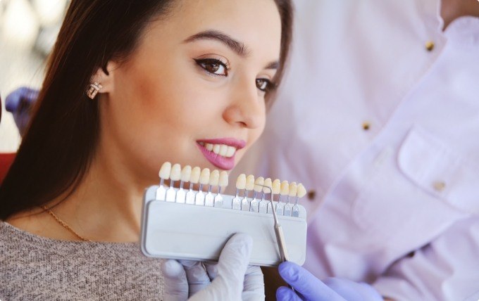 Young woman getting dental veneers from her cosmetic dentist in Moorestown