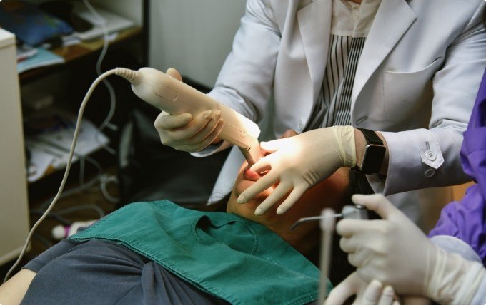 Dentist taking digital dental impressions of a patient's mouth