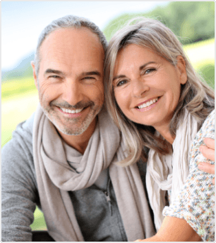 Smiling older couple hugging outdoors