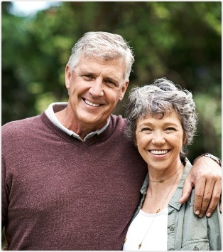 Senior man and woman smiling together outdoors