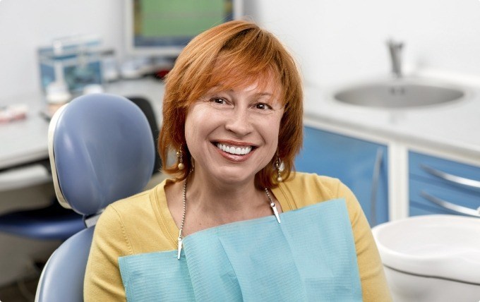 Redheaded woman smiling during preventive dentistry visit in Moorestown