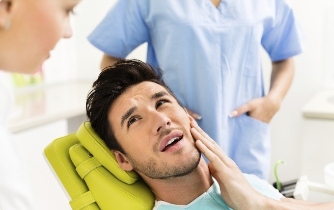 Man with jaw pain talking to dentist about T M J treatment in Moorestown